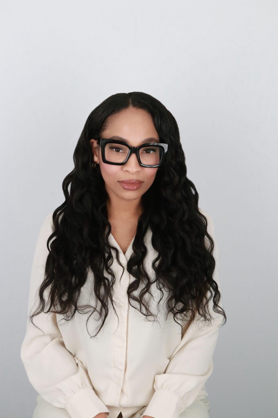 A high-scoring professional headshot with clean lighting, a simple background, and an engaged expression