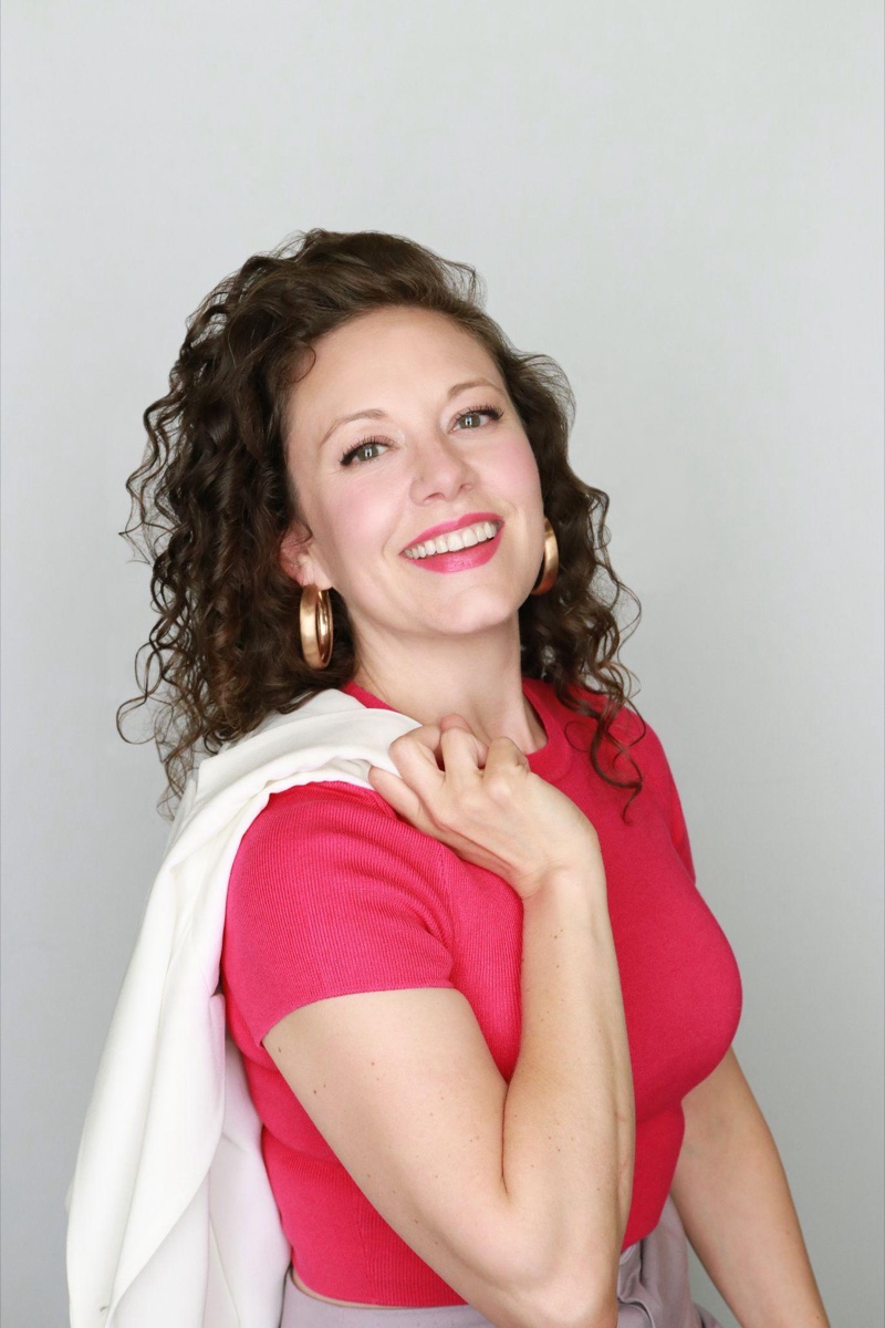 Creative-industry headshot example: an expressive, stylized studio portrait with a bolder, more personal wardrobe choice