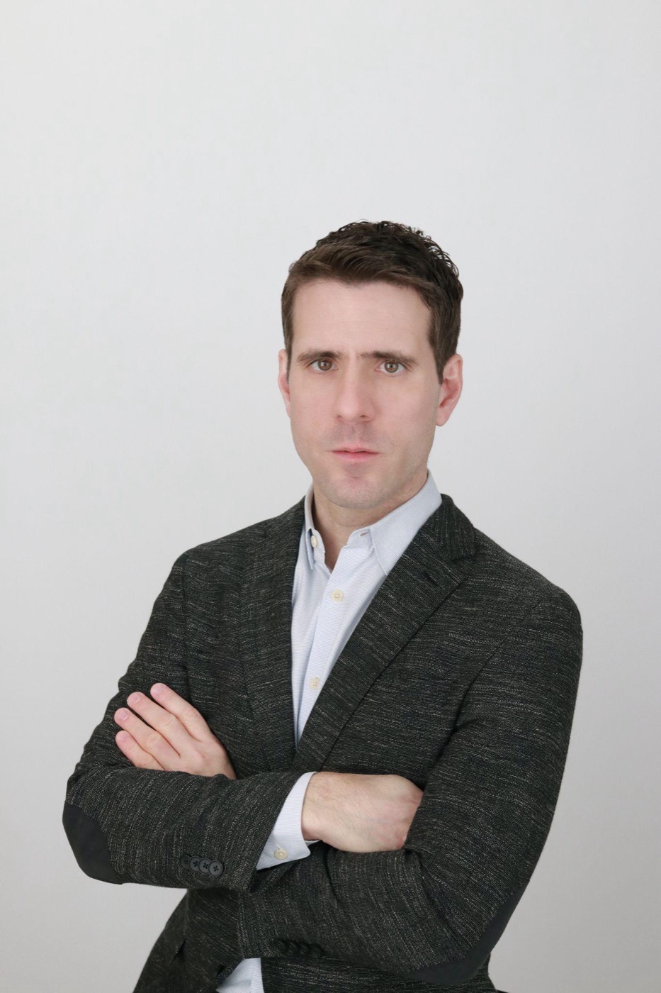 A polished, natural-looking professional headshot produced in a low-pressure studio setup