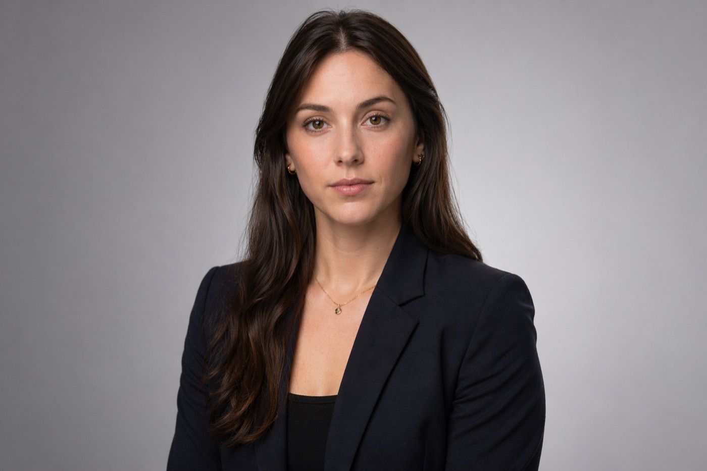 A classic posed studio headshot with controlled lighting, a clean backdrop, and a directed expression