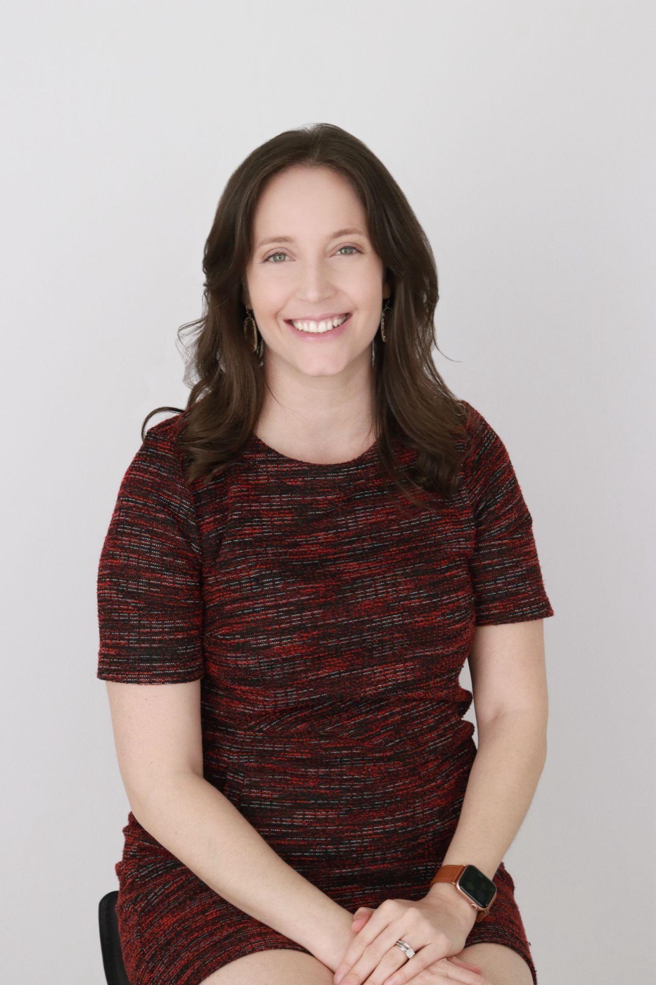 A professional headshot that looks polished yet natural, with a relaxed, believable expression