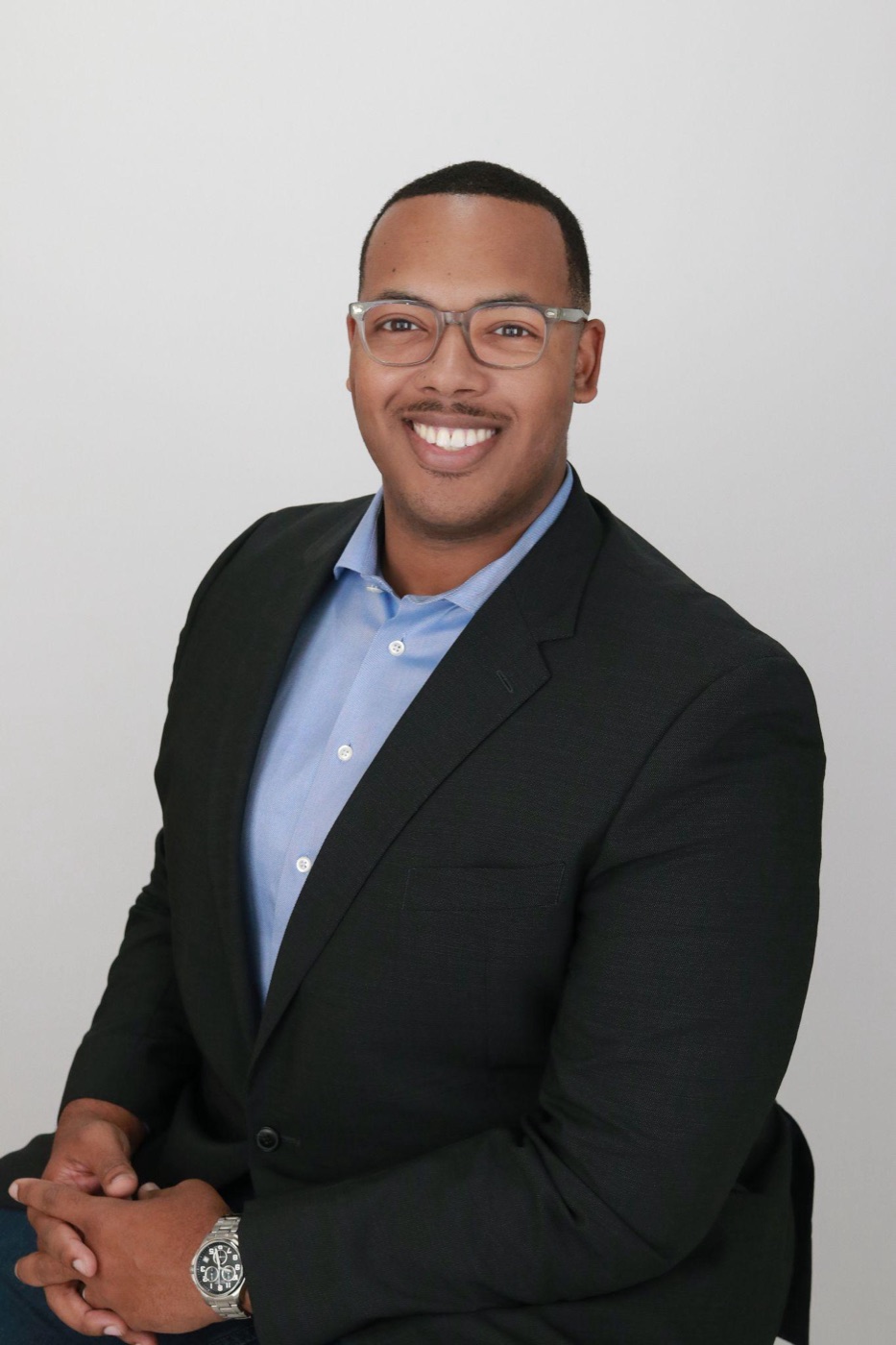 A natural professional headshot with subtle editing and realistic skin texture