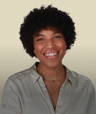 Company directory headshot, editorial framing, warm backdrop.